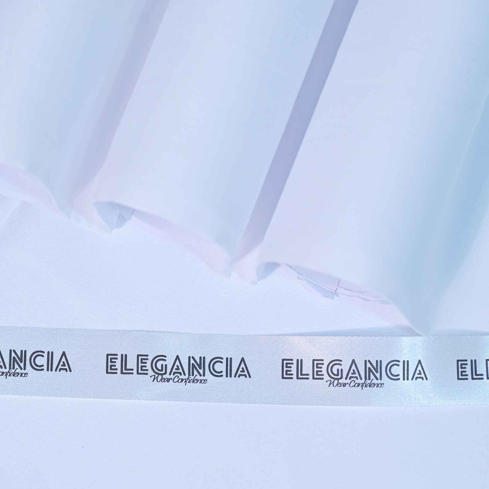 Close-up of ELEGANCIA fabric with a light blue background